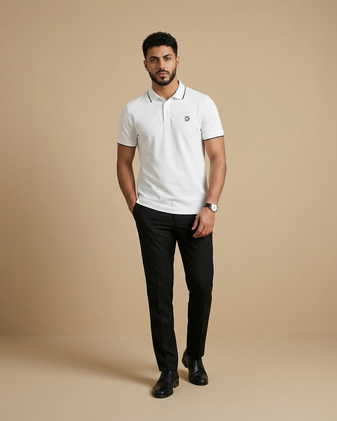 Man wearing a Cloud polo shirt and black pants on a beige background